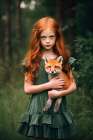Little girl holding baby fox. AI Generated. Art Print